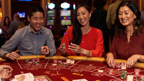 Three people playing Baccarat