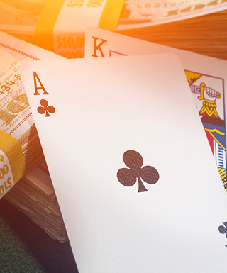 Ace and King on stack of cash with gold lighting