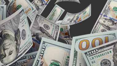 Cash flying on black background