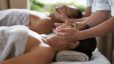 man and a woman getting facial massage