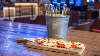 Flatbread pizza with a bucket of beer
