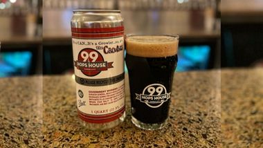 A Dark beer and Crawler on a bar